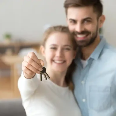 young couple with home keys